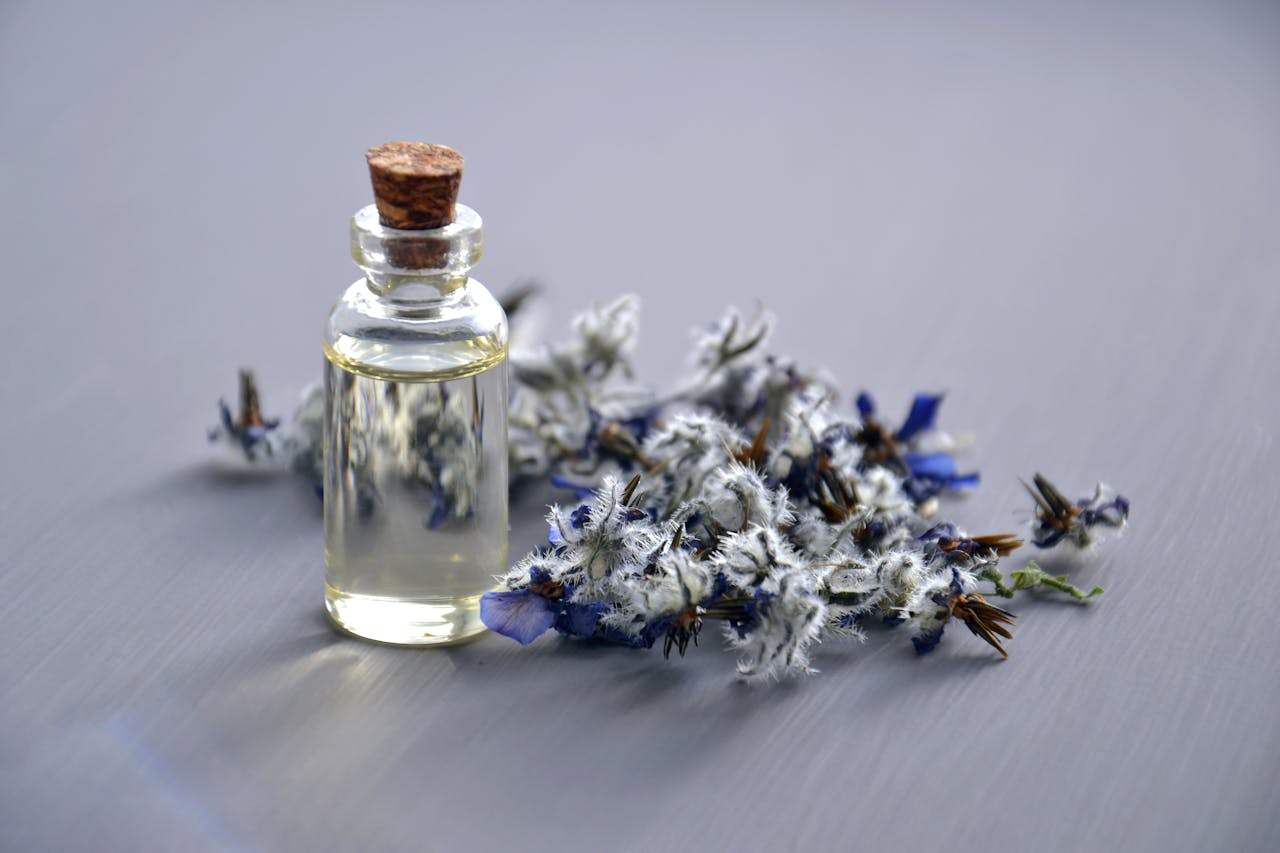 Close-up of a lavender oil bottle with dried flowers for aromatherapy. Perfect for wellness themes.